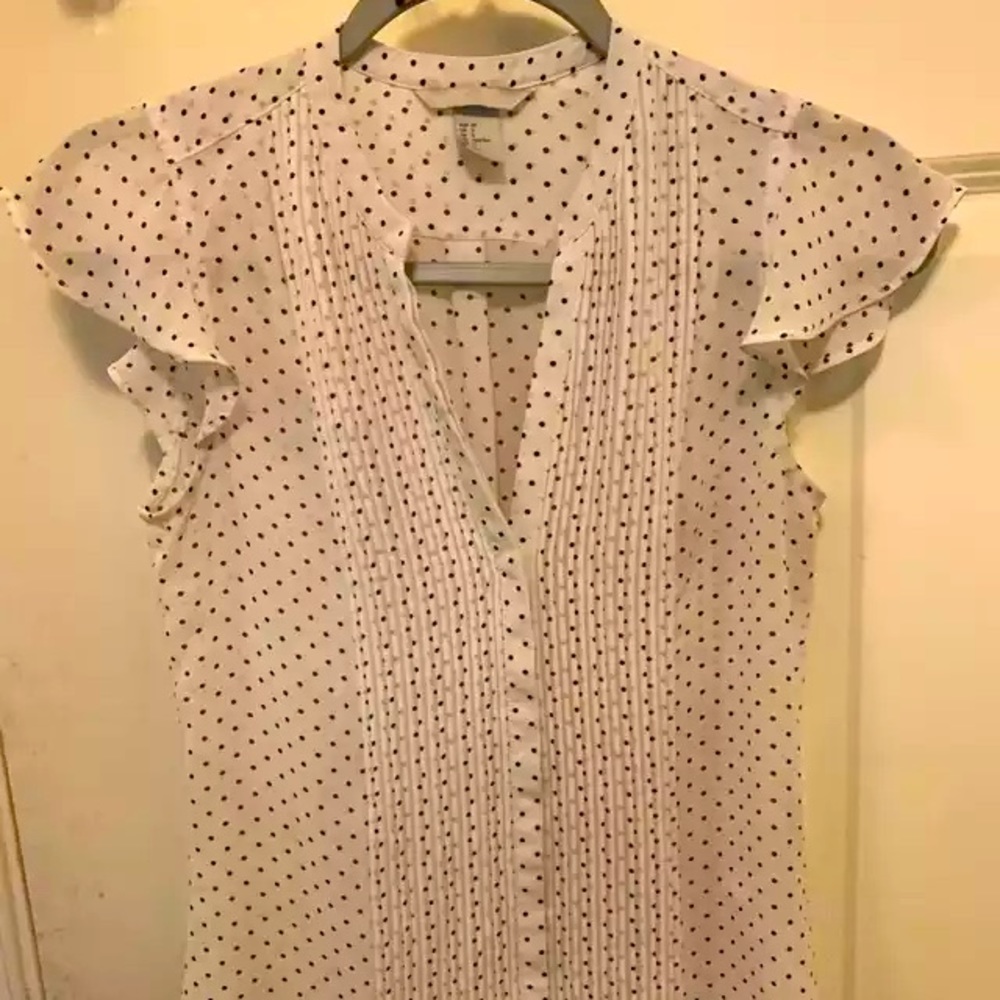 White V-neck blouse with black dotted pattern